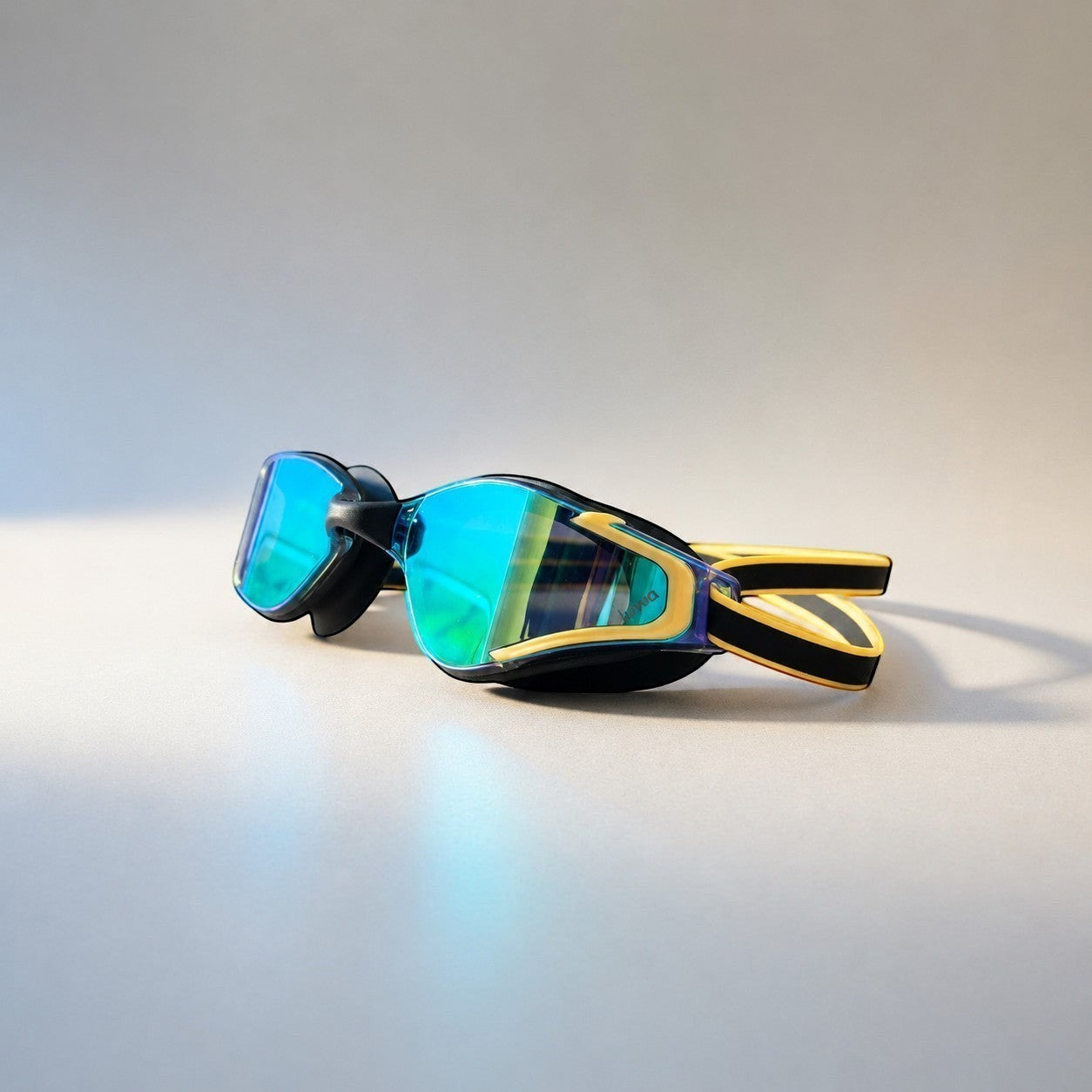 luwa Apex Elite black and gold swim goggles with blue mirrored lenses and adjustable strap.