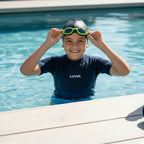 luwa Coral Flash swim goggles in black and neon green with anti-fog PC lens and adjustable nose bridge.