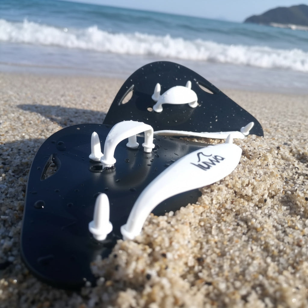 luwa black and white swim paddles with adjustable straps for training and technique improvement.